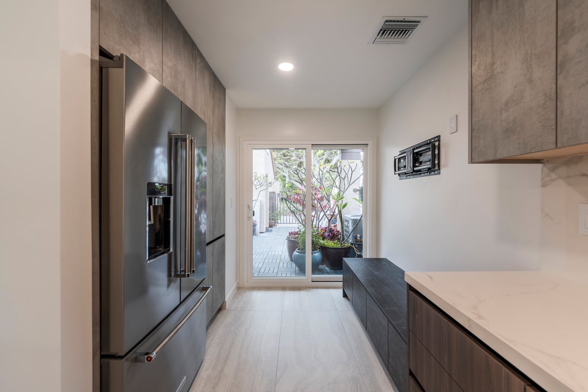 Custom dual tone cabinetry with double door stainless refrigerator