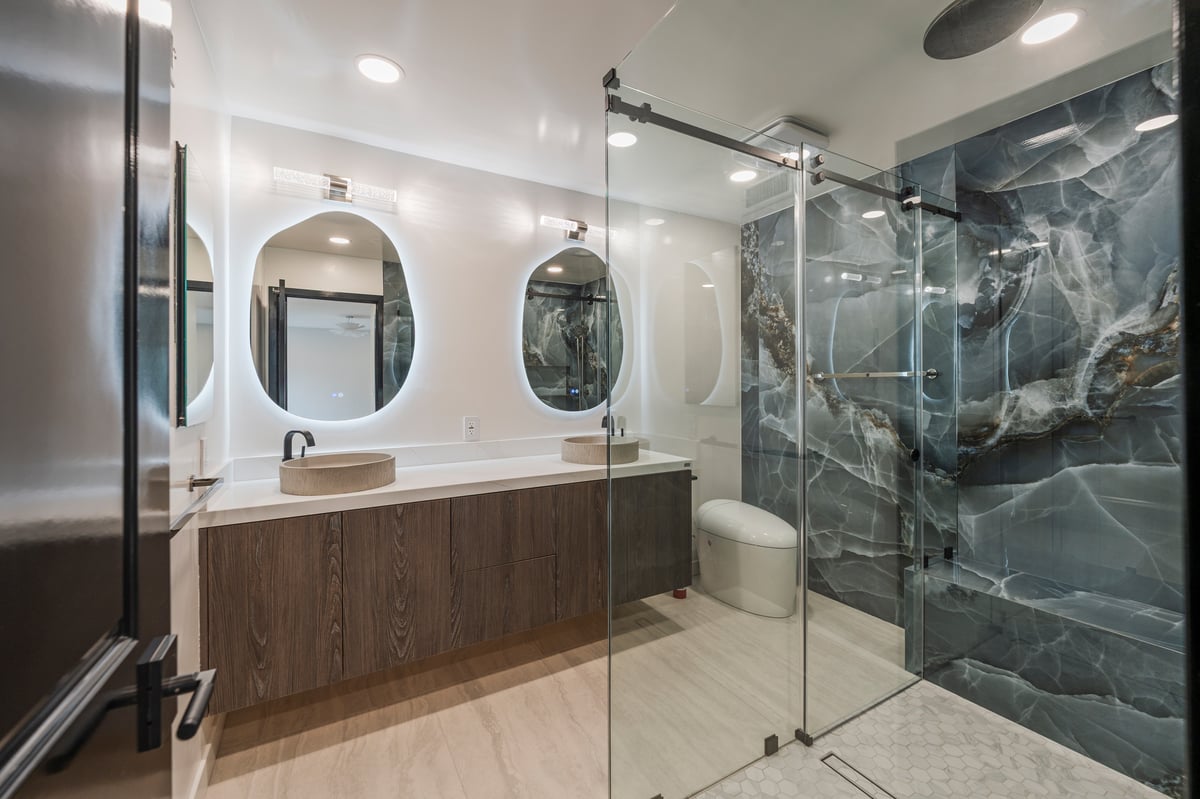 Custom shower with large-format blue porcelain tiles and matte black fixtures.