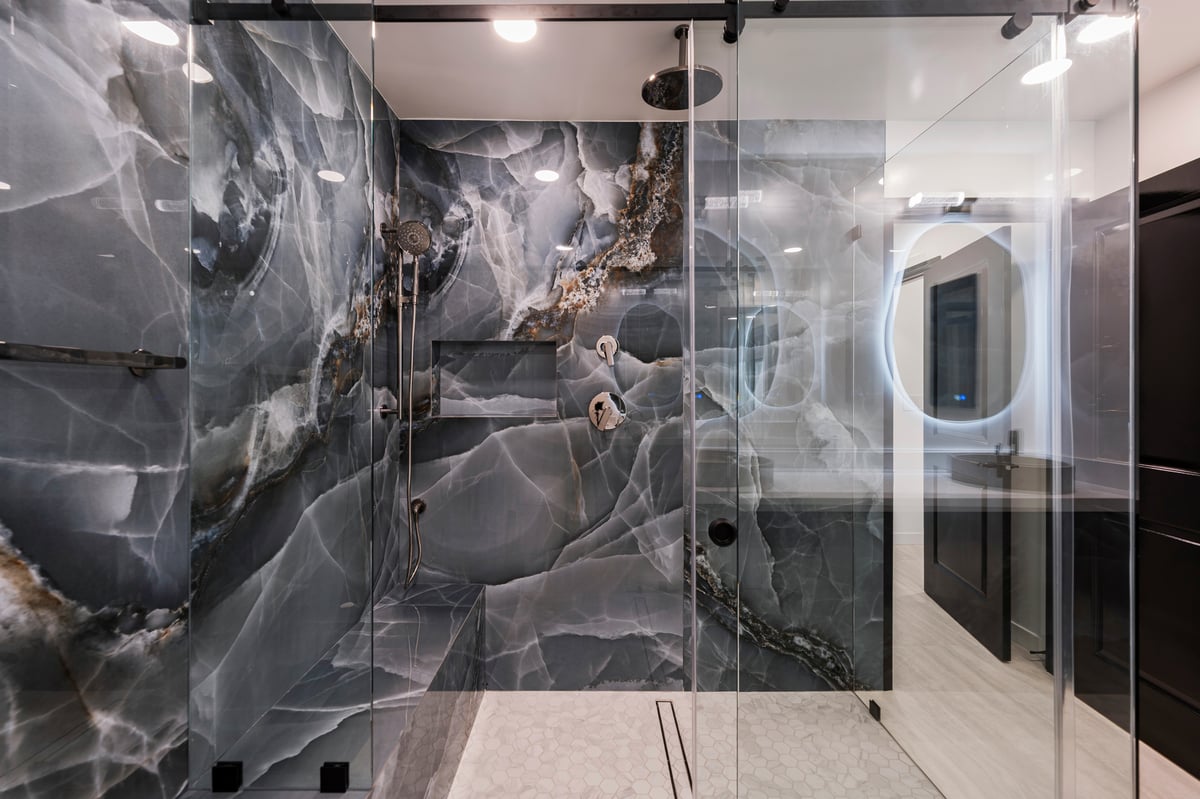 Frameless custom glass shower with statement tile with shades of blue