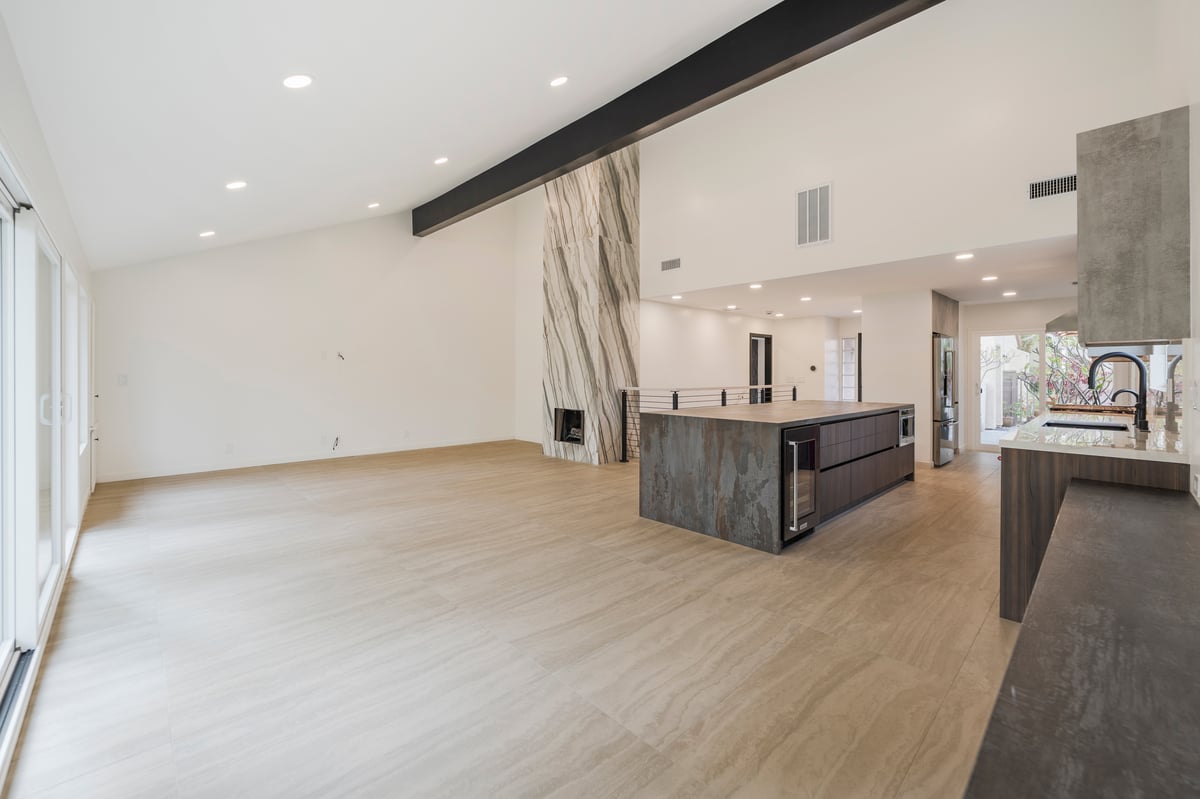 Living space with open sightlines to modern fireplace and staircase
